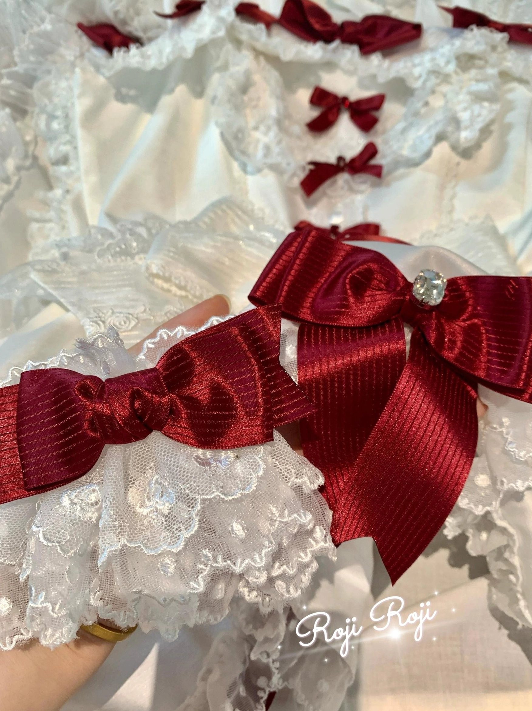 Strawberry Angel wine red bow Sweet Lolita wrist cuffs close-up showing satin bow detail and lace texture