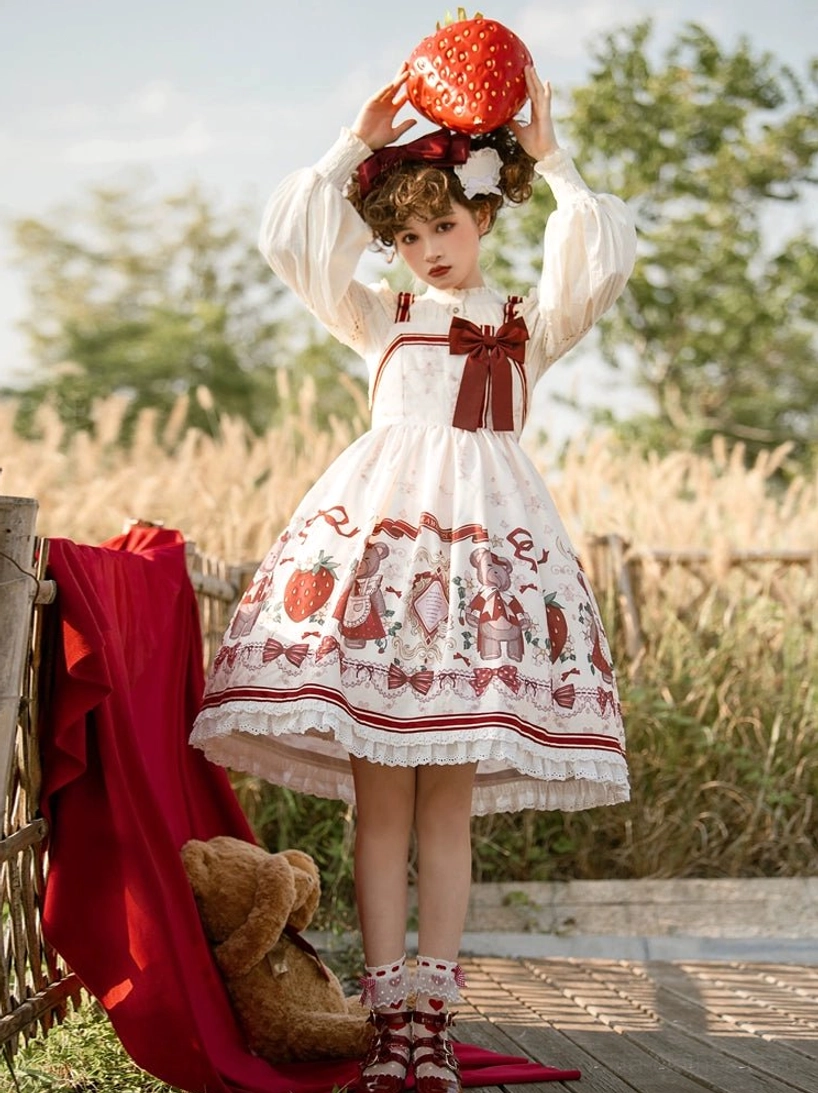 strawberry bear printed lolita jumper skirt front full-body model holding large strawberry prop ivory base burgundy details