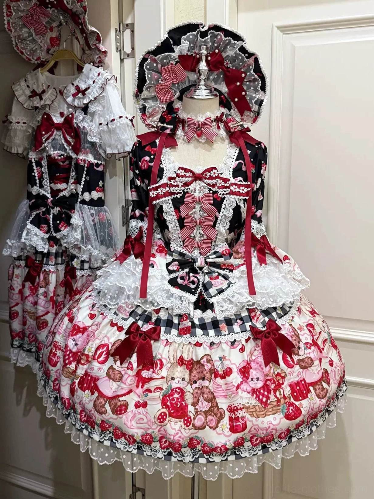 Sweet lolita OP dress detail view showing strawberry and bear print pattern, polka dots, delicate lace trims, and fabric texture of four-way stretch material