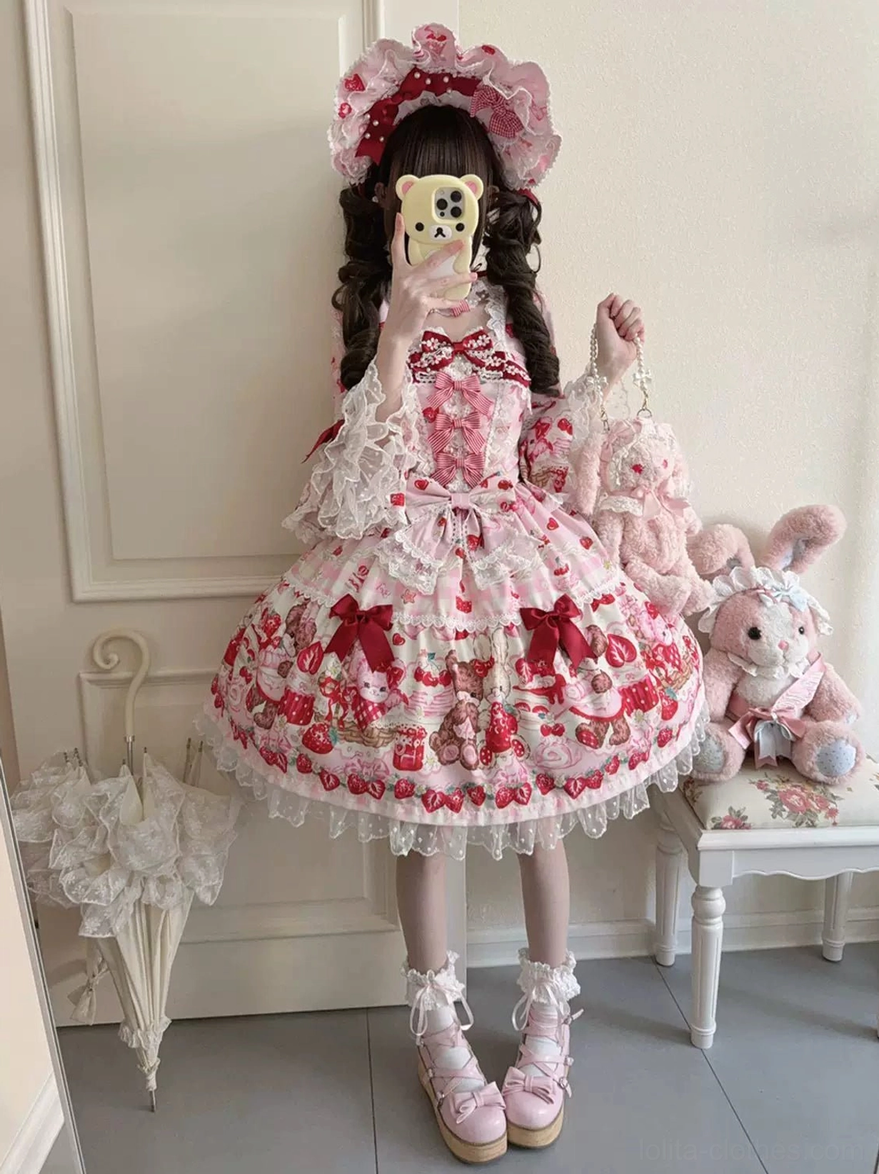 Sweet lolita OP dress hime sleeve detail showing puffed sleeve construction, neckline bow with floral trim, and upper bodice design elements photographed close-up