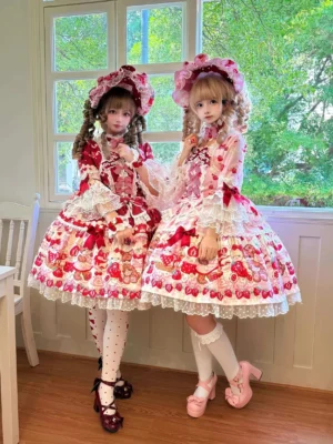 Two lolita models wearing matching strawberry bear sweet lolita OP dresses with hime sleeves, showcasing front coordinate view with bonnets, Mary Jane shoes, and tights