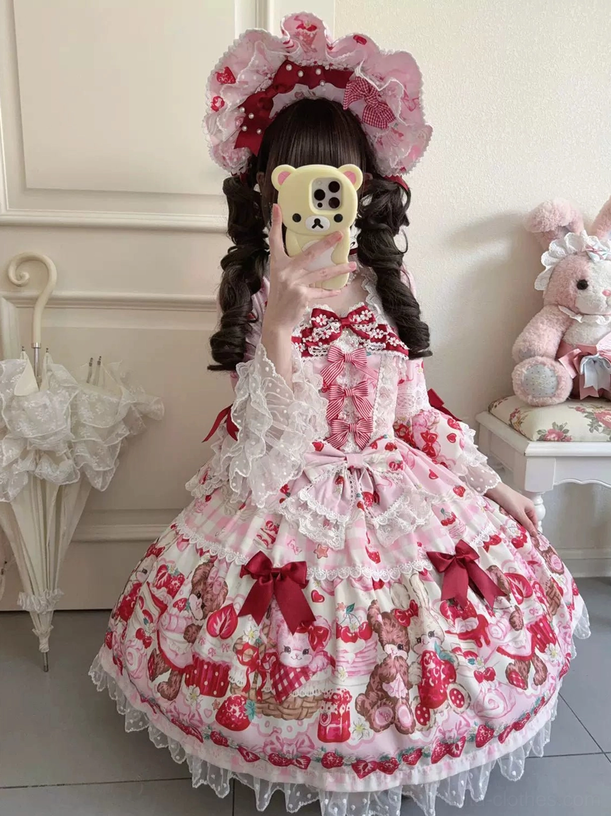 Strawberry bear print lolita one-piece waist detail showing plaid spliced hem construction, layered ruffles, lace trim, and transition from bodice to full skirt