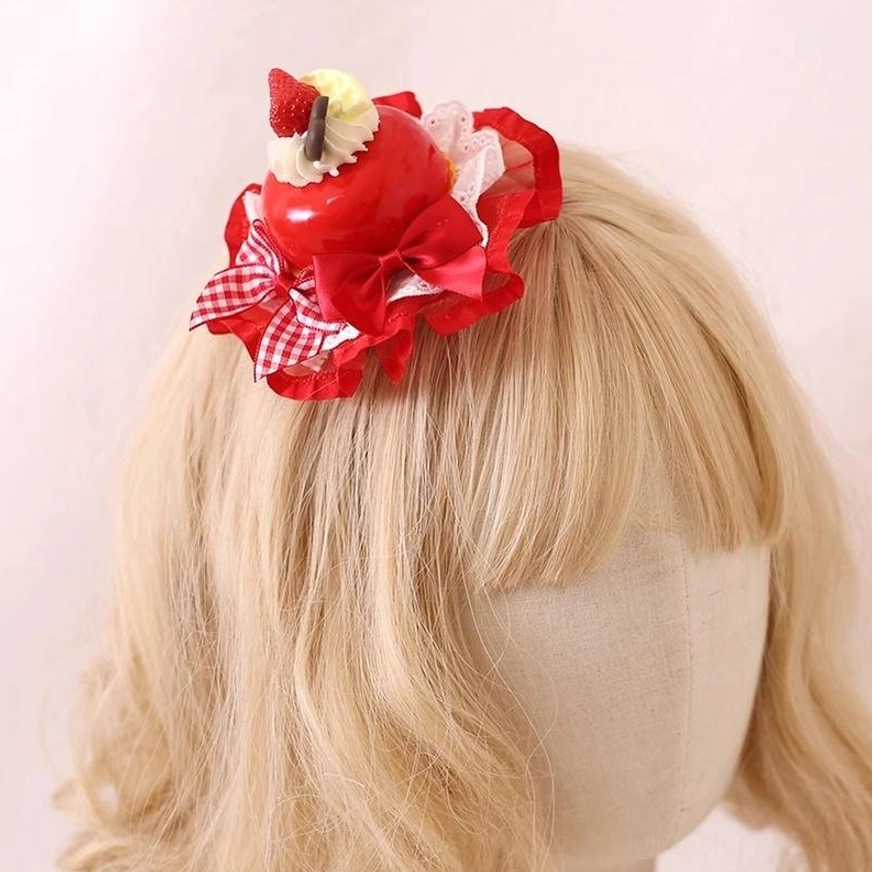 Red strawberry dessert Lolita headdress hairpin worn on blonde mannequin wig showing side back view with decorative bow and intricate lace trim details