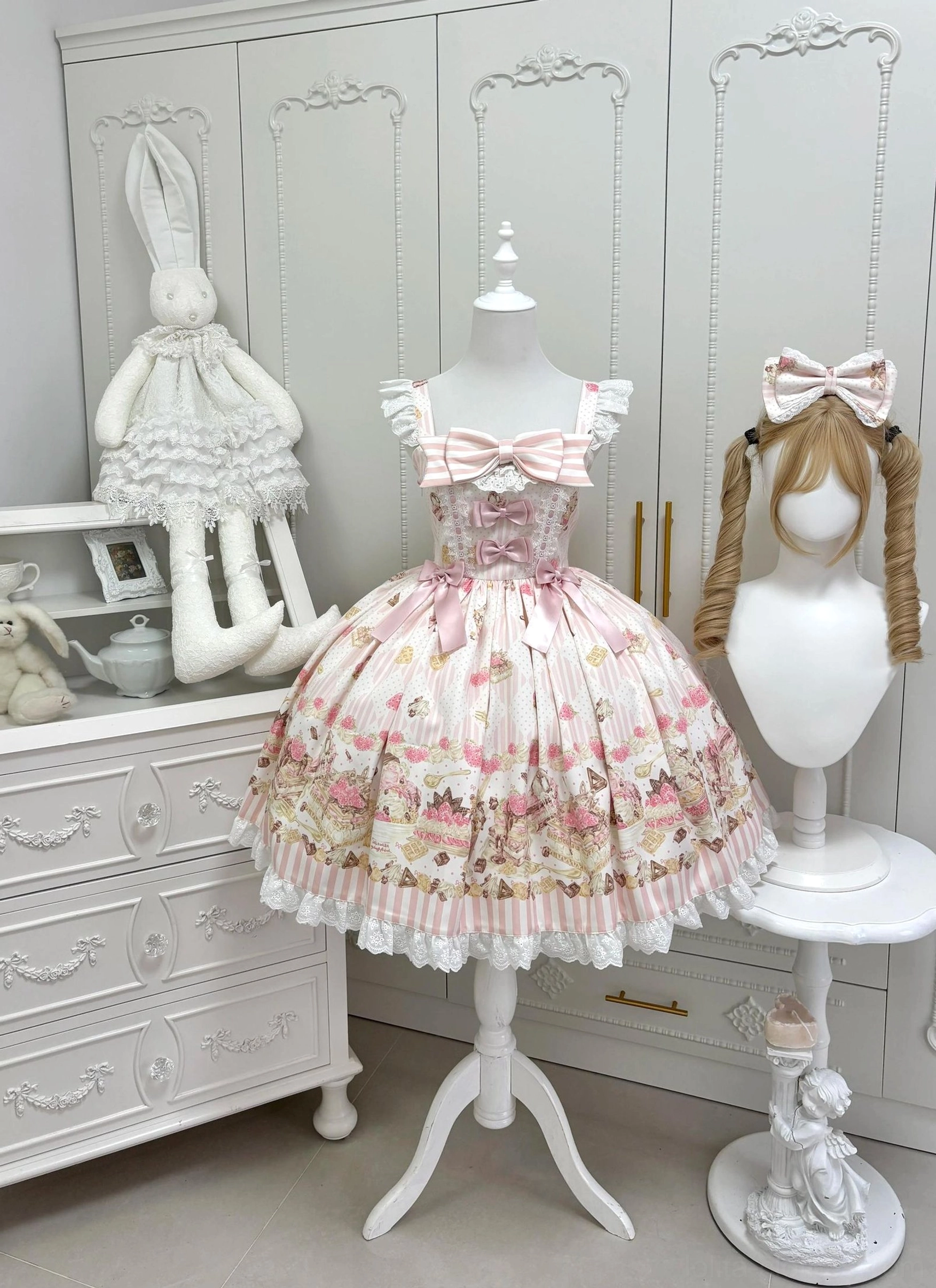 Iced Strawberry Cheese Sweet Lolita JSK dress front view flat lay showing pink strawberry dessert print pleated skirt with ruffled lace hem and chest bow decoration
