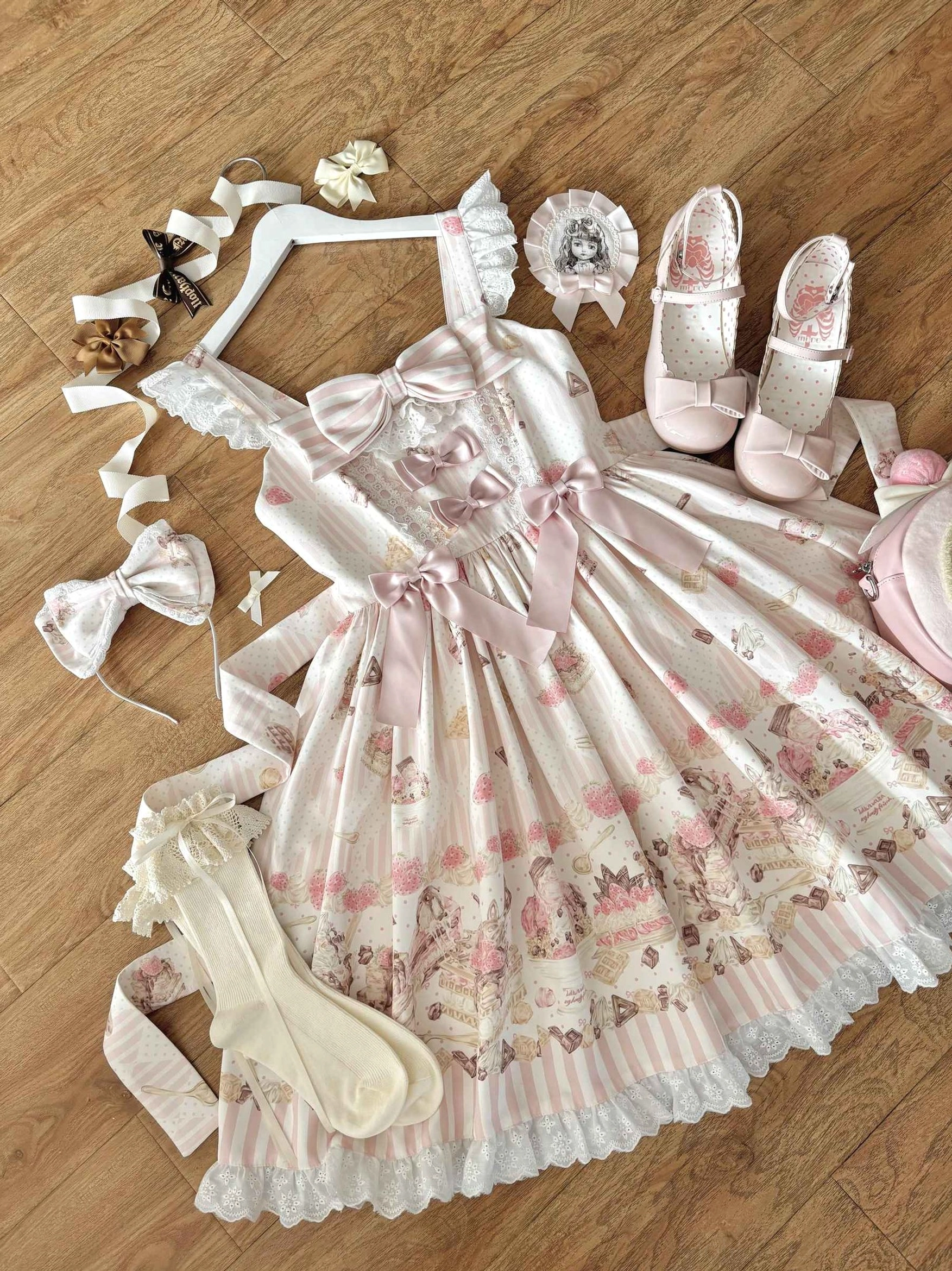 Iced Strawberry Cheese Sweet Lolita JSK dress side view flat lay showing front chest bow pleated strawberry print skirt ruffled lace hem wooden floor background