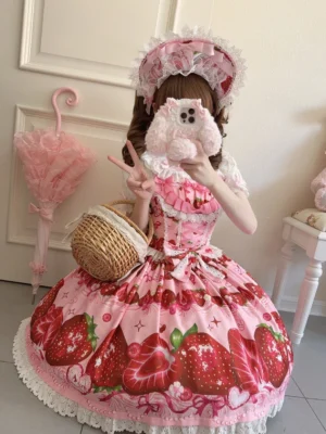 Pink strawberry Lolita jumper skirt dress with lace ruffled hem and square neckline, half-body front showcase with wicker picnic basket accessory