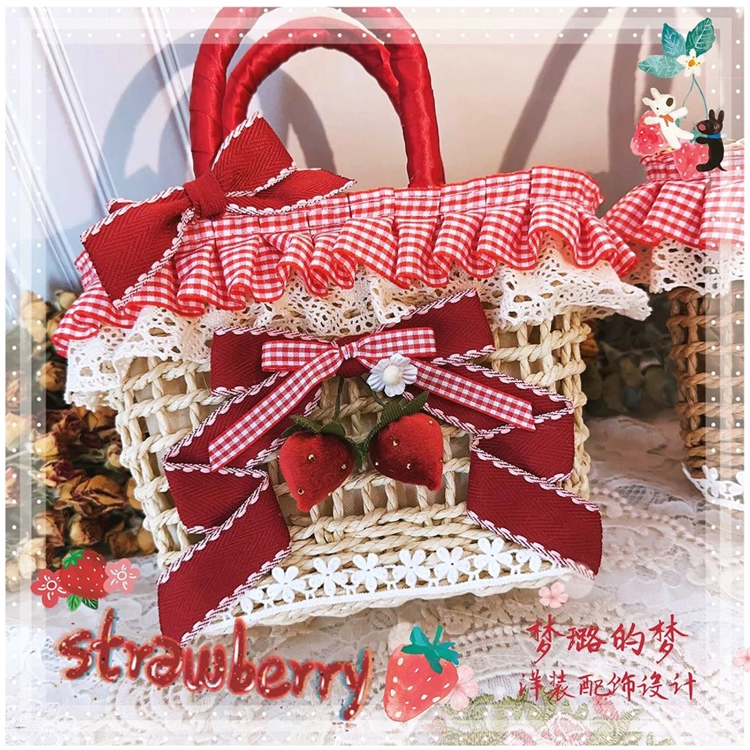 Front close-up of strawberry gingham Country Lolita straw tote bag featuring woven texture, red bows, lace trim and fruit charms