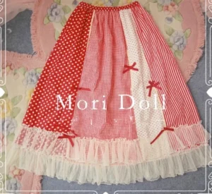 Strawberry jam sweet lolita patchwork skirt overhead flat lay featuring red polka dot stripe and gingham patchwork panels with beige lace hemline and red ribbon bows on floral decorative rug