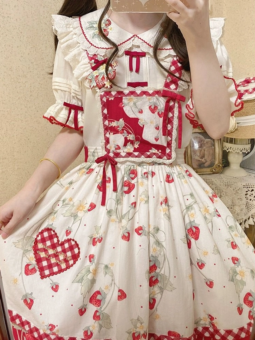 Girl wearing strawberry sweet lolita blouse holding matching strawberry print skirt back mirror selfie view showing complete coordinate in vintage room setting
