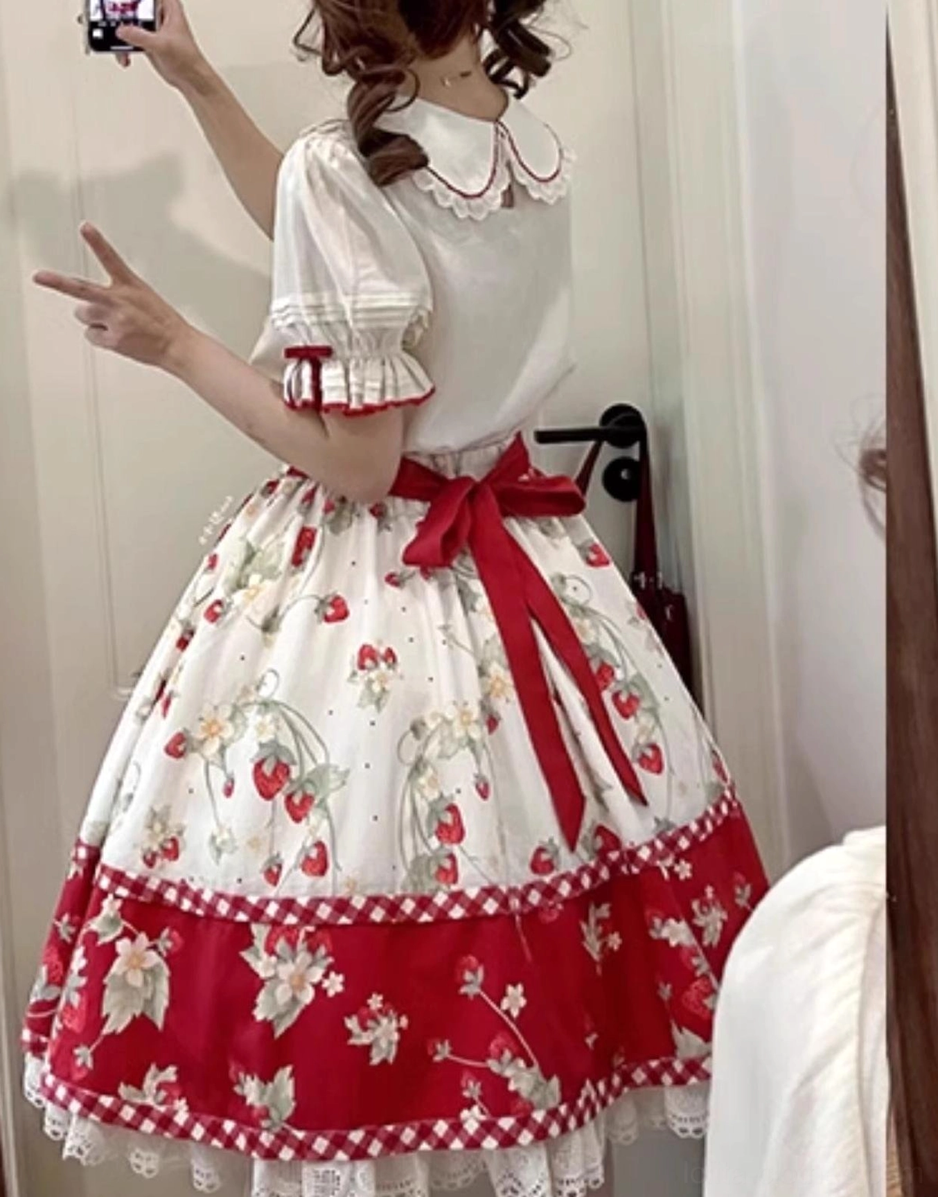 Strawberry print and embroidery detailing on ivory sweet lolita blouse showing color accuracy and stitching quality close-up view