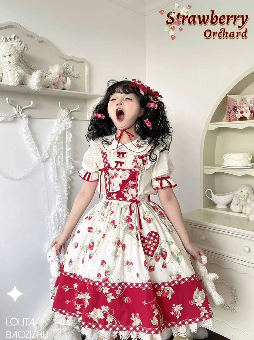 Red ribbon bow accent on chest of ivory strawberry sweet lolita blouse showing removable bow attachment point and decorative placement