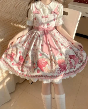Girl wearing strawberry print lolita dress with matching white blouse underneath, indoor bedroom setting, full-body front view of complete coordinate