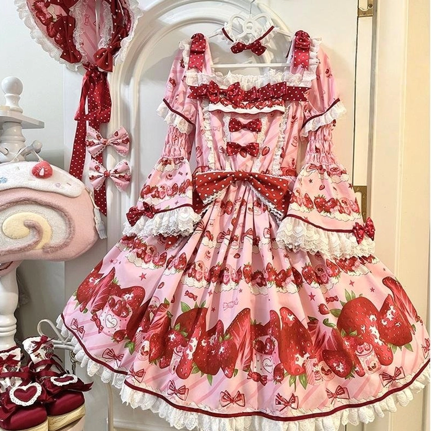 Strawberry sweet lolita OP dress flat lay display front view with square ruffled neckline flounced lace sleeves large front bow and matching lolita accessories