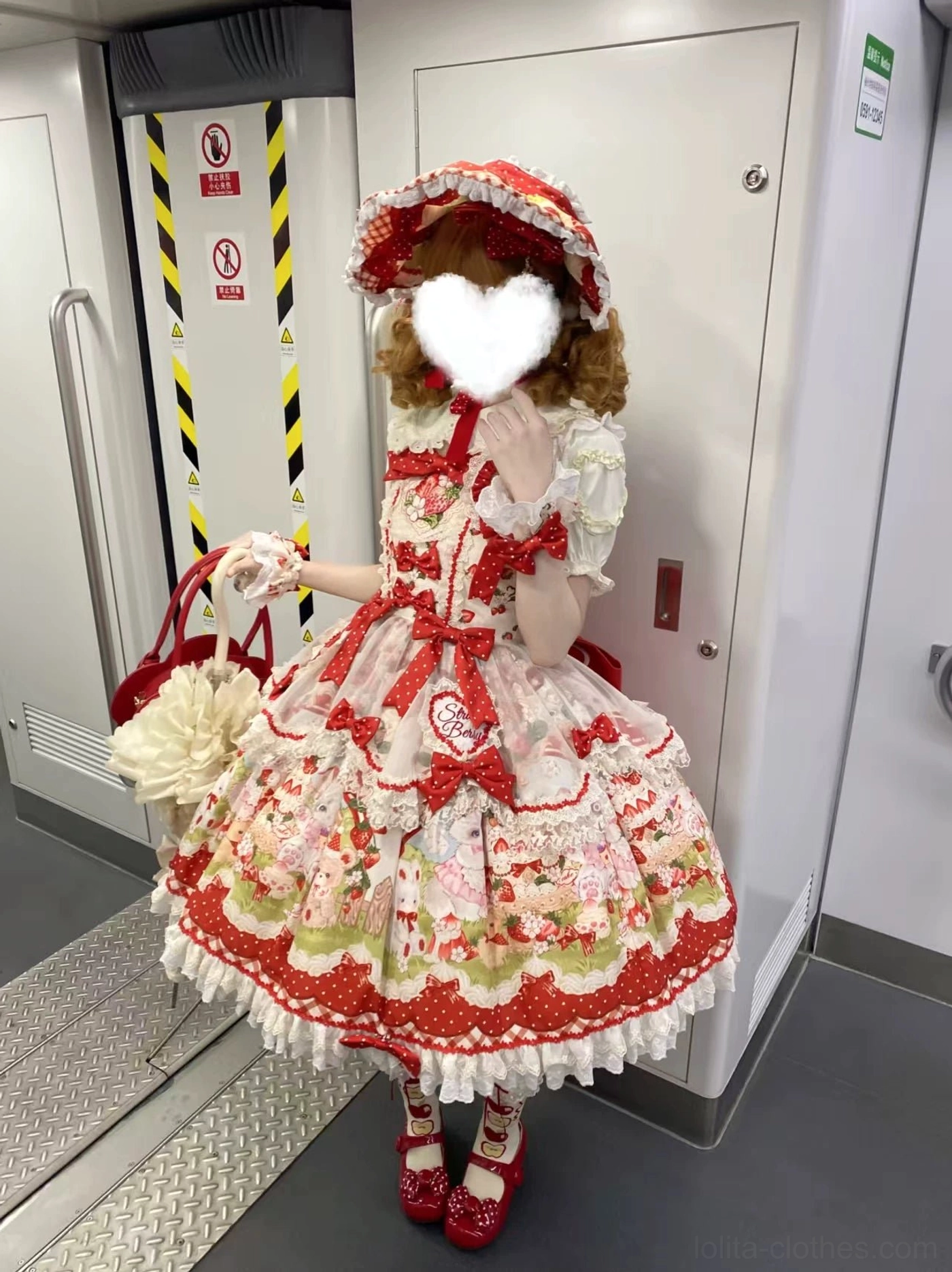 Strawberry Lolita JSK dress embroidery close-up detail showing handcrafted strawberry embroidered chest design, delicate needle work, artistic detailing of sweet Lolita aesthetic