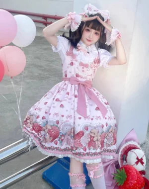 Sweet lolita JSK strawberry dress low angle shot model posing with pink balloons wearing ruffled cuffs and waist bow