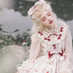 Strawberry sweet lolita JSK close-up upper body front detail showing lace ruffled neckline red bows scattered strawberry prints large front waist bow