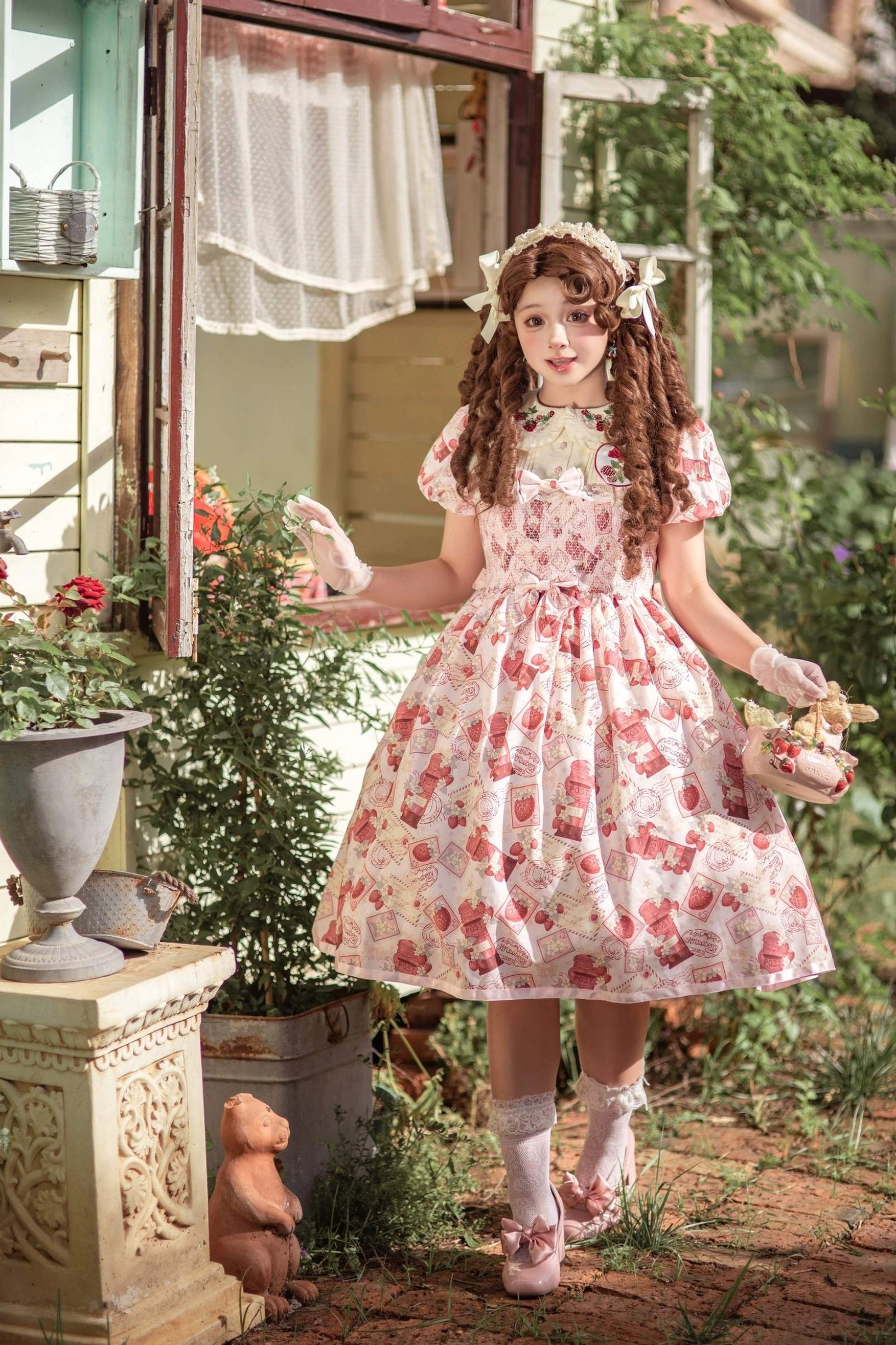 Strawberry print Lolita OP dress worn with decorative ankle boots, ruffled socks, and charm accessories, demonstrating footwear styling recommendations for lolita aesthetic