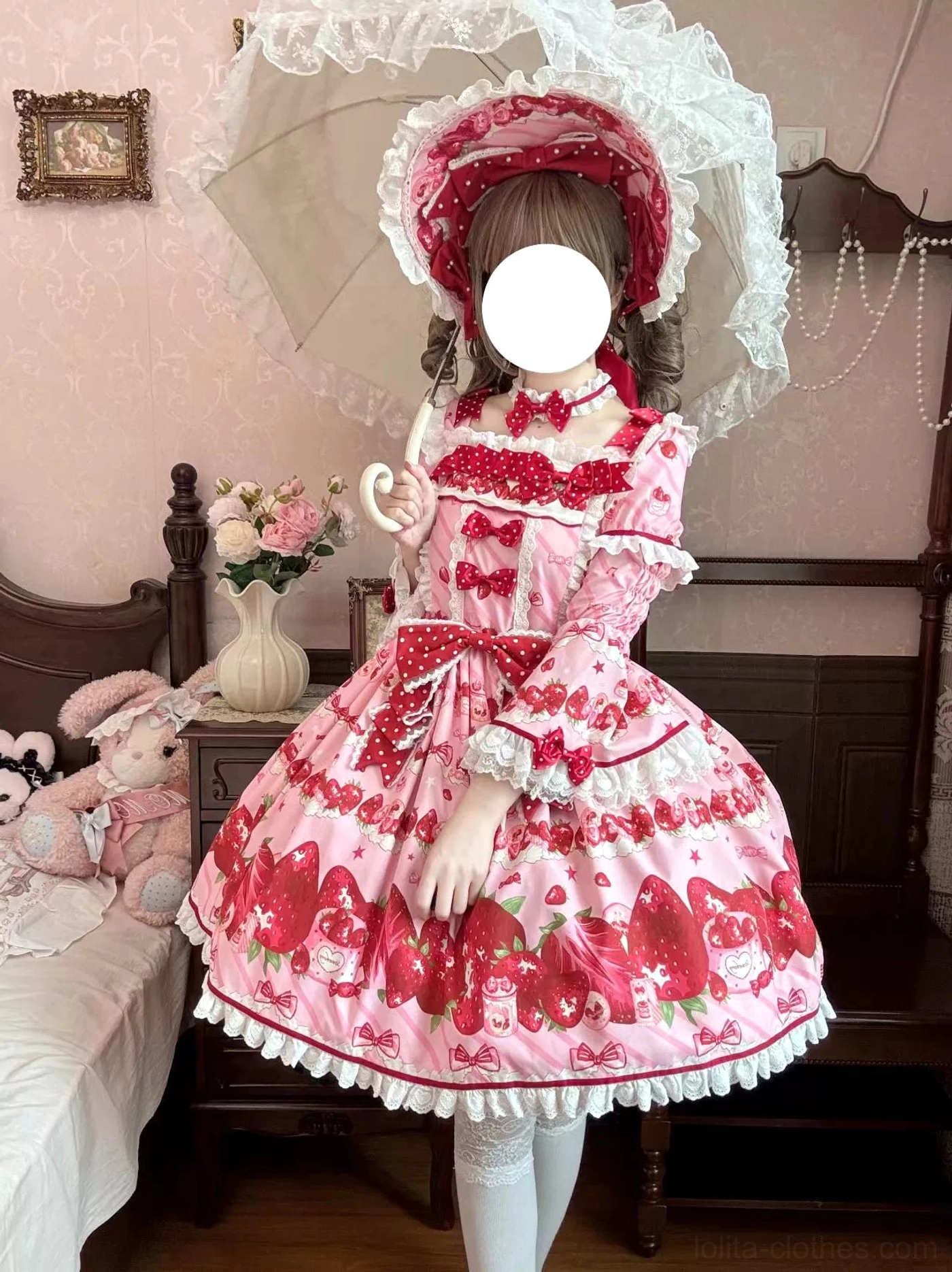 Model wearing strawberry lolita outfit with white lace parasol front full body portrait vintage bedroom lace decor ruffled sleeve cuffs bonnet lace veil trim