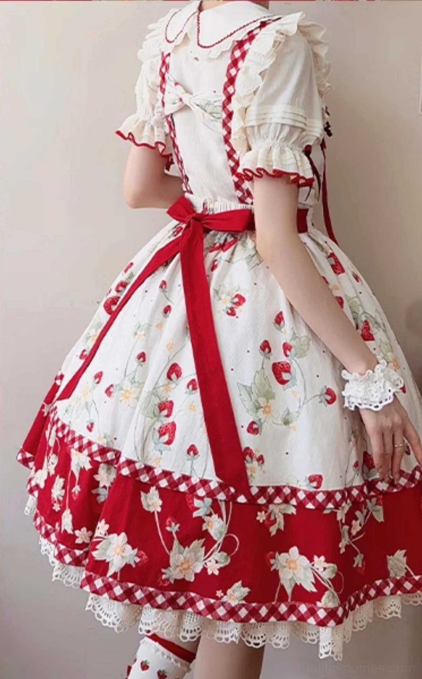 Full front view of girl wearing ivory strawberry sweet lolita blouse styled with complete lolita coordinate at outdoor location