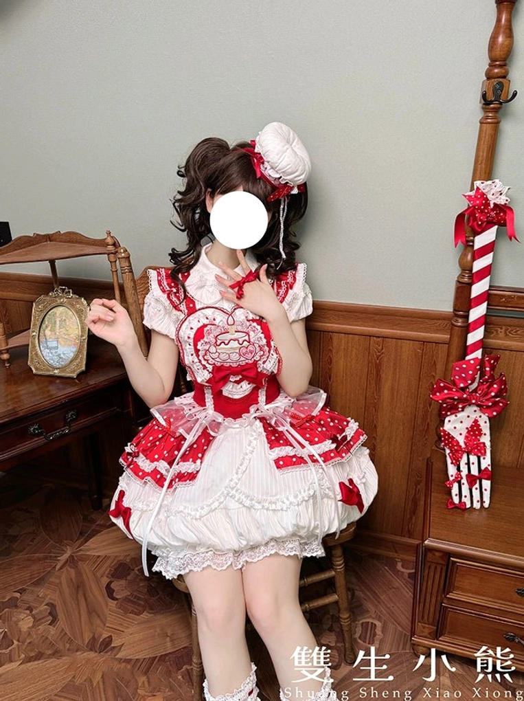 Blurred half-body sitting view of lolita model wearing strawberry sweet dress with heart bear embroidery, bow trims, bubble hem skirt on vintage wooden furniture
