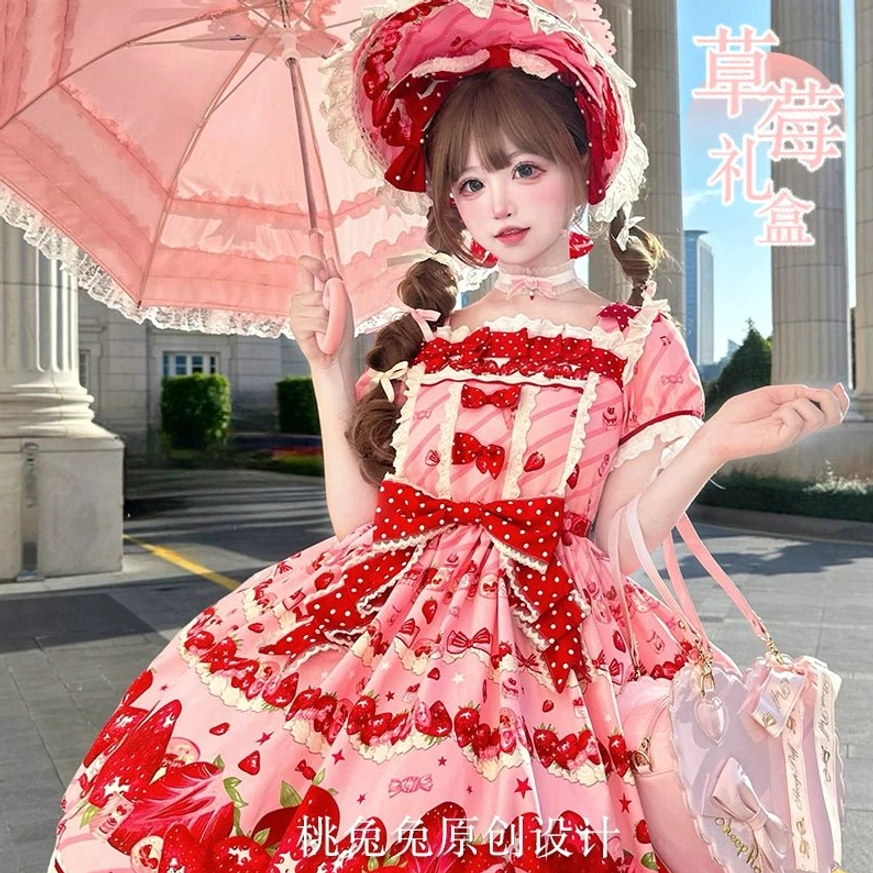 Strawberry print sweet lolita one-piece dress front full view on model wearing red lace bonnet pink lace umbrella and matching accessories European street outdoor location
