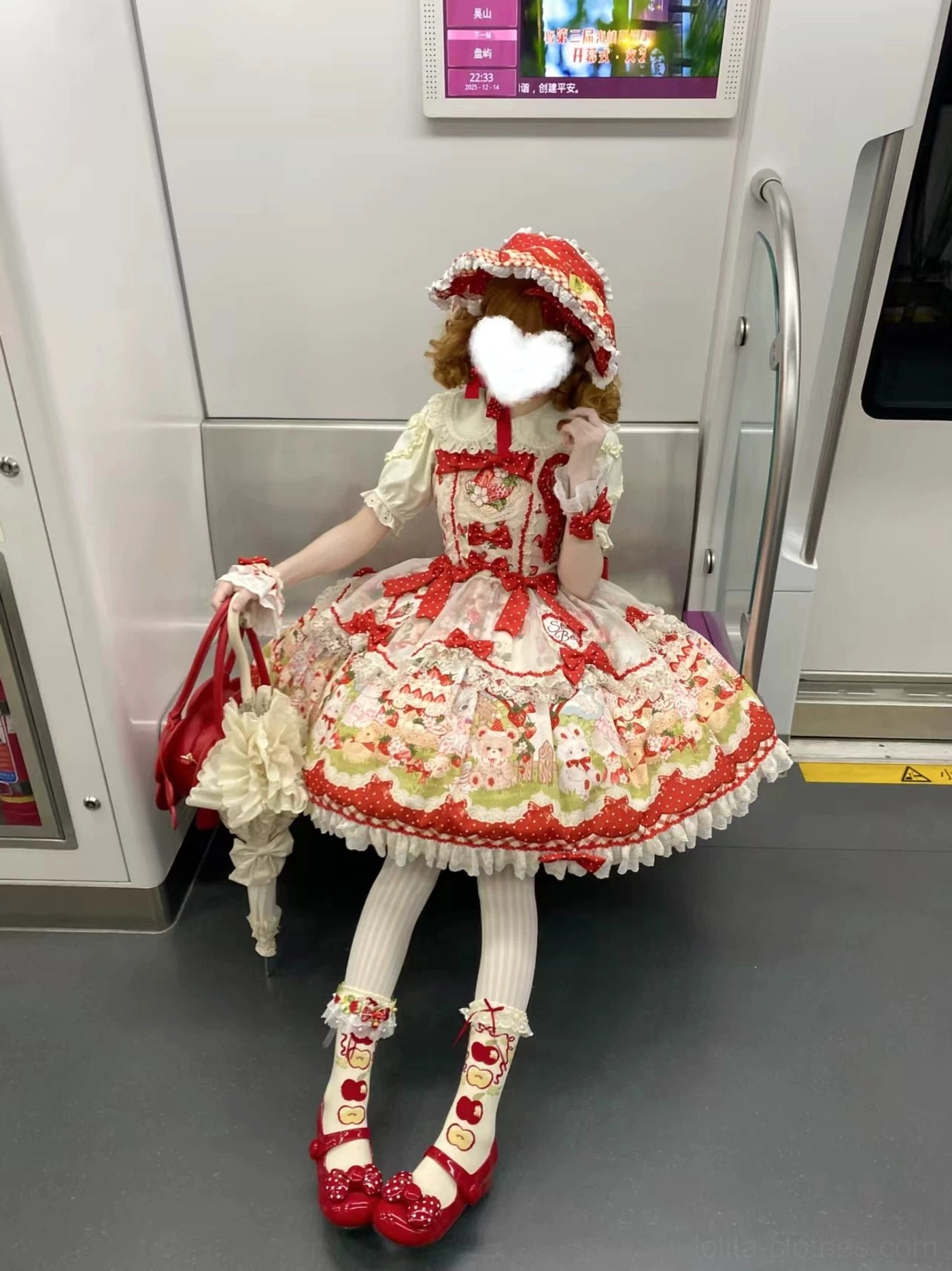 Strawberry sweet Lolita JSK dress hem detail close-up showing scalloped lace border with polka dot pattern resembling strawberry seeds, ruffled trim design element, fabric quality showcase