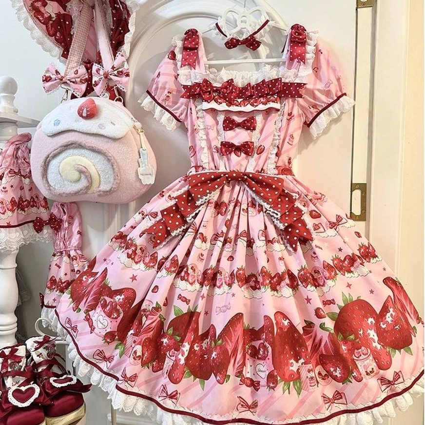 Strawberry print sweet lolita one-piece dress flat lay front view showing pink strawberry polka dot pattern lace-trimmed neckline detachable large waist bow