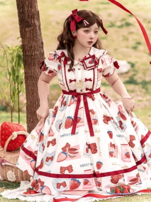 Strawberry sweet lolita OP dress front three-quarter view with puffed sleeves ruffled collar and red ribbon waist sash on outdoor lawn picnic setting
