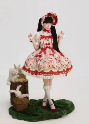 Strawberry tea party sweet Lolita JSK dress front full-body view with matching bonnet, featuring red off-white color scheme, adorable strawberry dessert print with kittens bears and bunnies, ruffled lace hem with polka dot details, and coordinating red bow trims on woodland decor background