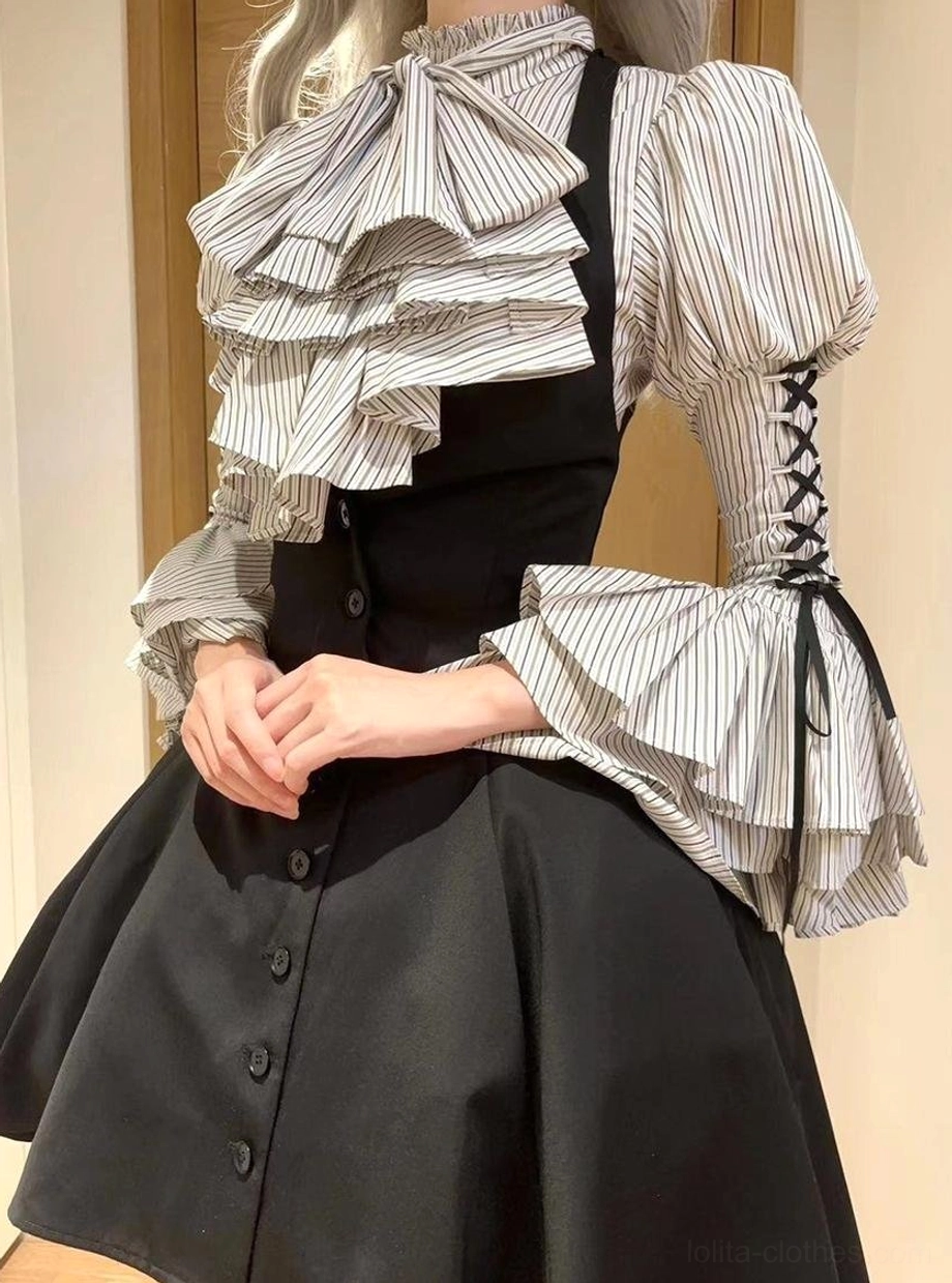 Front close-up of person wearing striped Gothic Lolita blouse showing detailed ruffled jabot, lace-up puff sleeves and stripe pattern with front button placket, styled with black waistcoat