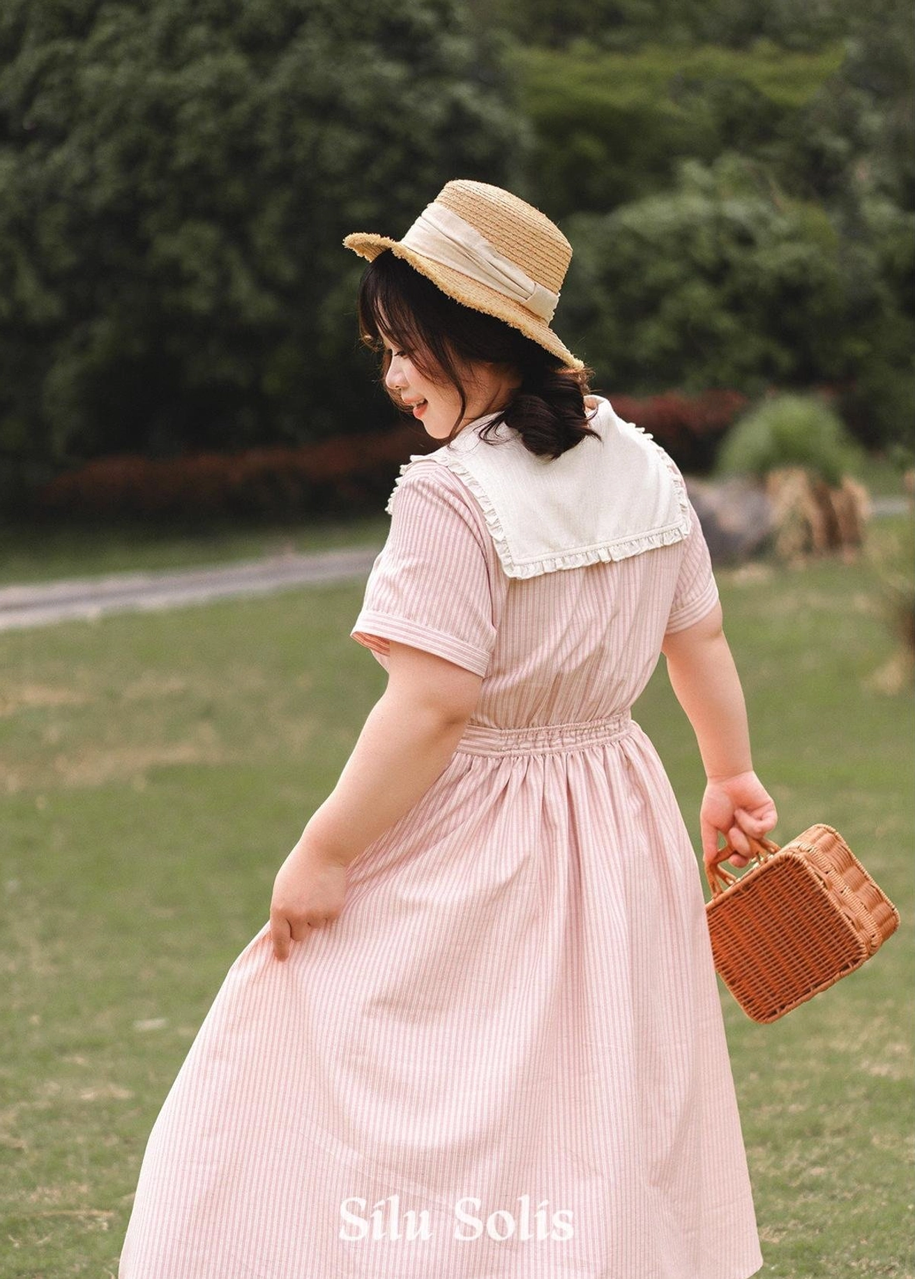 Side profile view of striped Lolita OP dress mannequin display showing silhouette, high waist cinch, skirt flare, and overall dress proportions