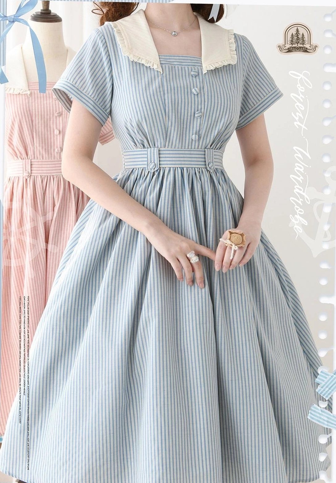 Overhead flat lay of folded striped Lolita OP dress showing fabric quality, stripe pattern alignment, and overall garment construction details