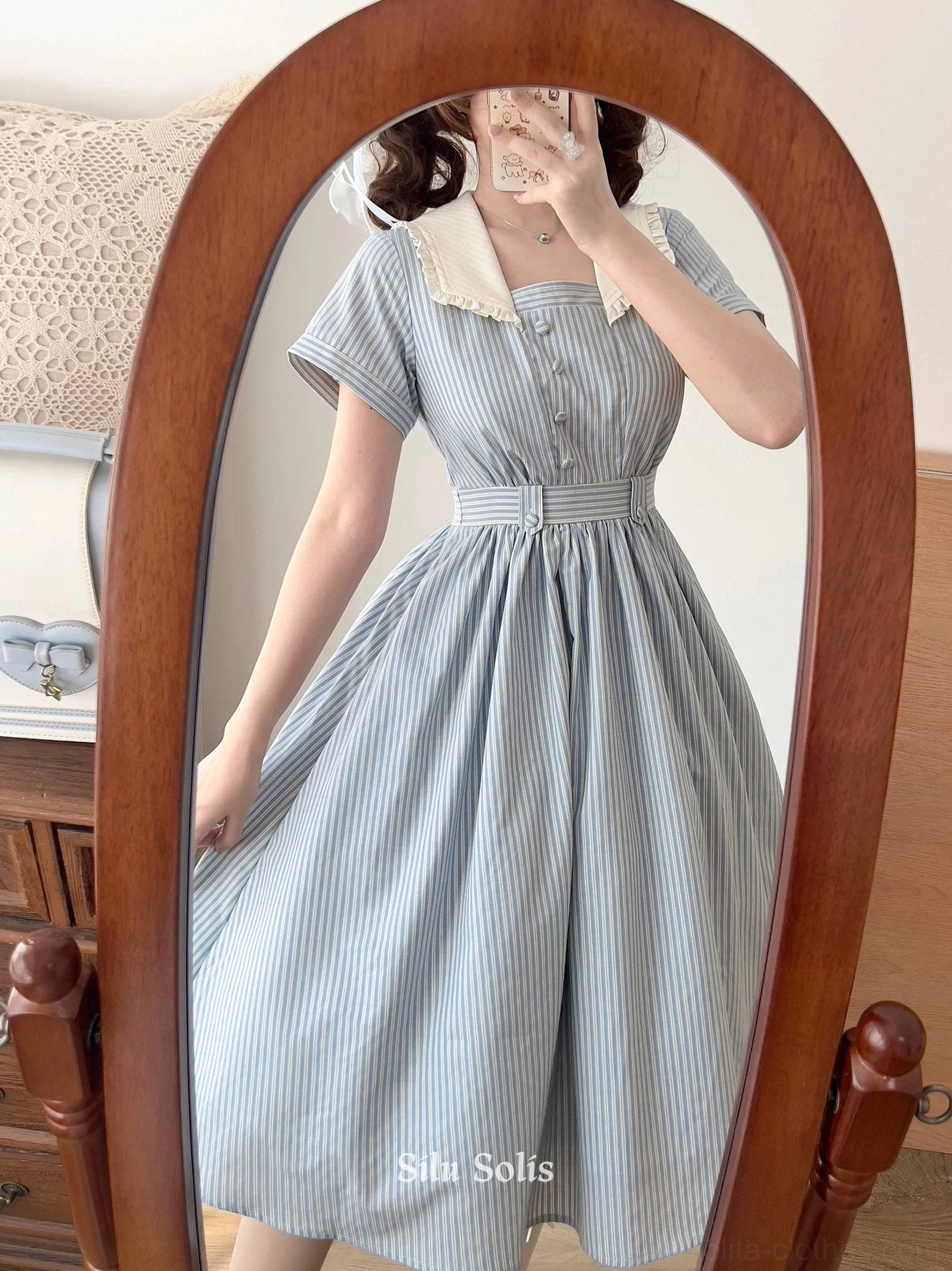 Full mannequin display of striped Lolita OP dress in studio setting with complementary vintage props, backdrop, and styling accessories for classic presentation