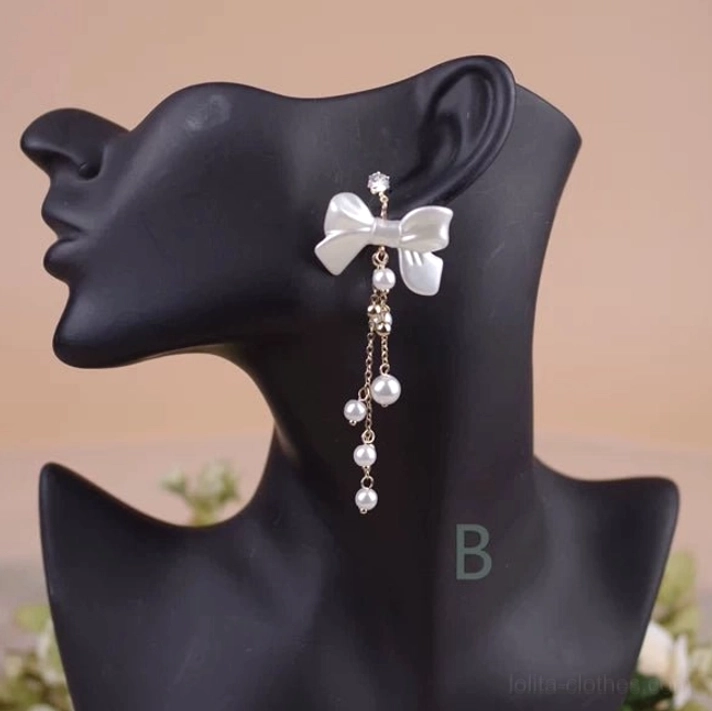 Classic Lolita Style B white bow pearl rhinestone clip-on dangle earring close-up detail view showing satin bow central rhinestone accent delicate gold chain and sequential pearl drop tassels