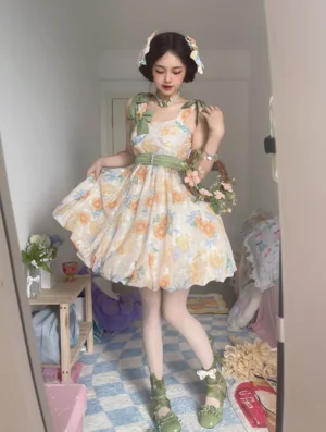 Sunflower print Lolita JSK dress worn by model in vintage bedroom with green waist sash and shoulder strap bows with sunflower ornaments