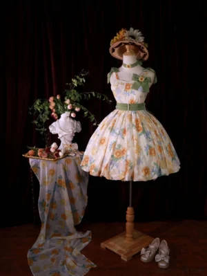Sunflower Lolita jumper skirt on mannequin display with matching headwear accessories and floral table decor in studio setting