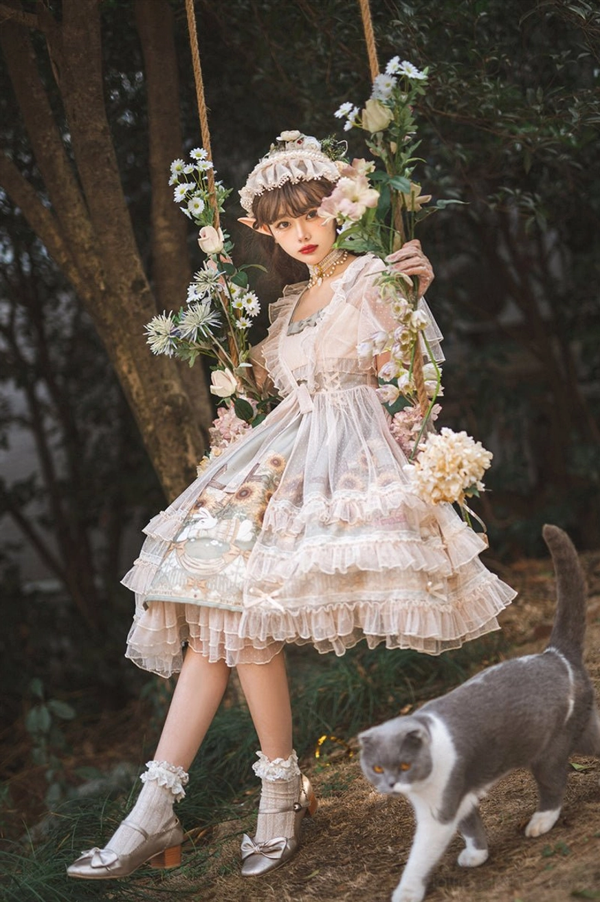 Sunflower printed lolita JSK dress full-body side shot on swing with model showing tiny waist tie delicate lace trims and square neckline detail