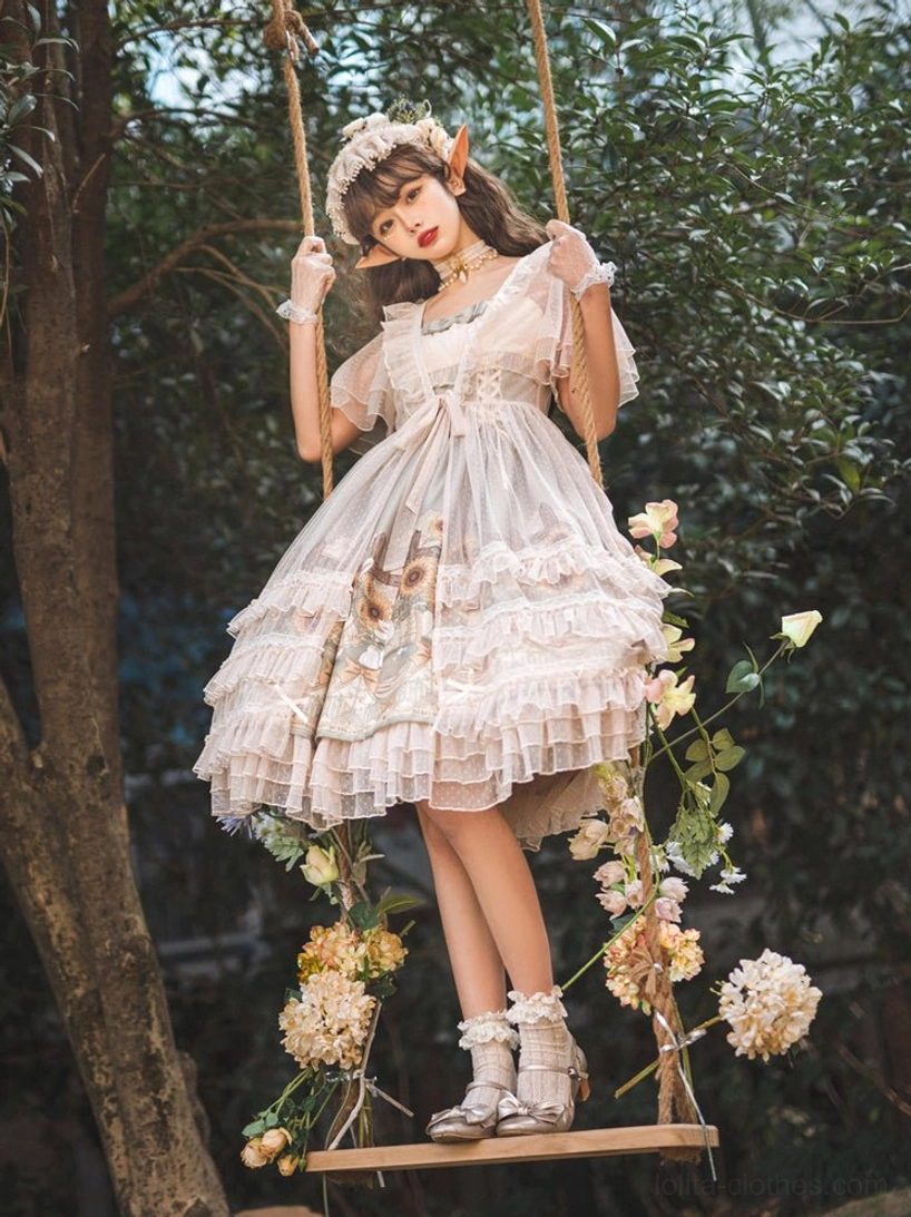 Sunflower printed lolita JSK dress full-body side view on model on flower-decorated garden swing showing sheer dress overlay ruffled tiered hem with flower hair accessory