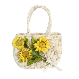 Front view of ivory woven sunflower straw Lolita handbag with three yellow flower decorations, green leaves, lace bow, and top handles