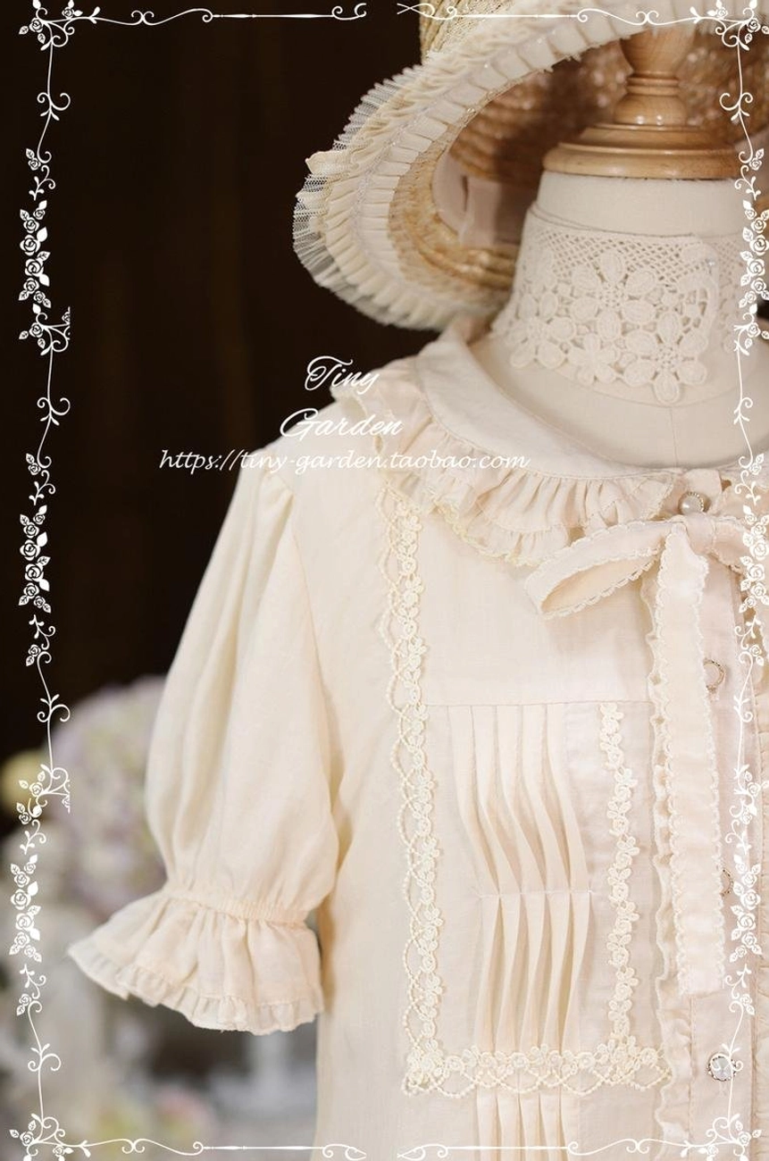 Close-up detail of beige Lolita blouse showing delicate dog-tooth edge collar, removable bow tie, lace-trimmed pleated front panel and ruffled cuff construction