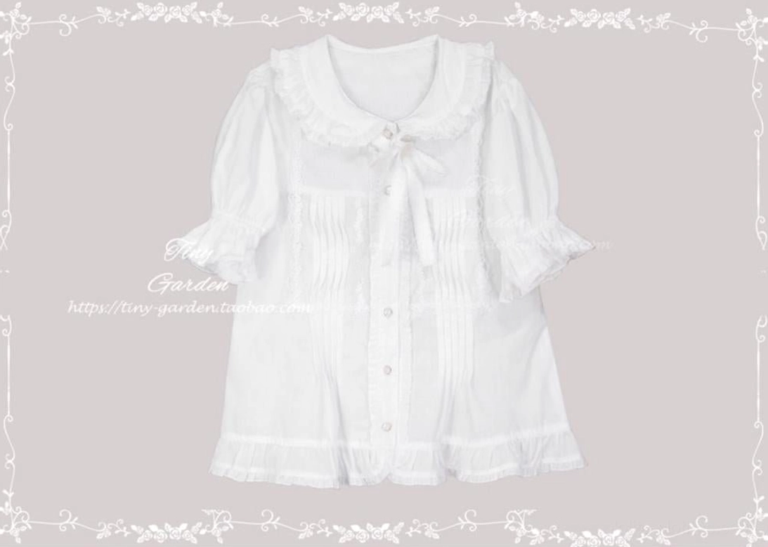 Short-sleeve white Peter Pan collar Lolita blouse with removable bow tie, front view showing pleated chest panel and ruffled cuff details, flat lay product photography