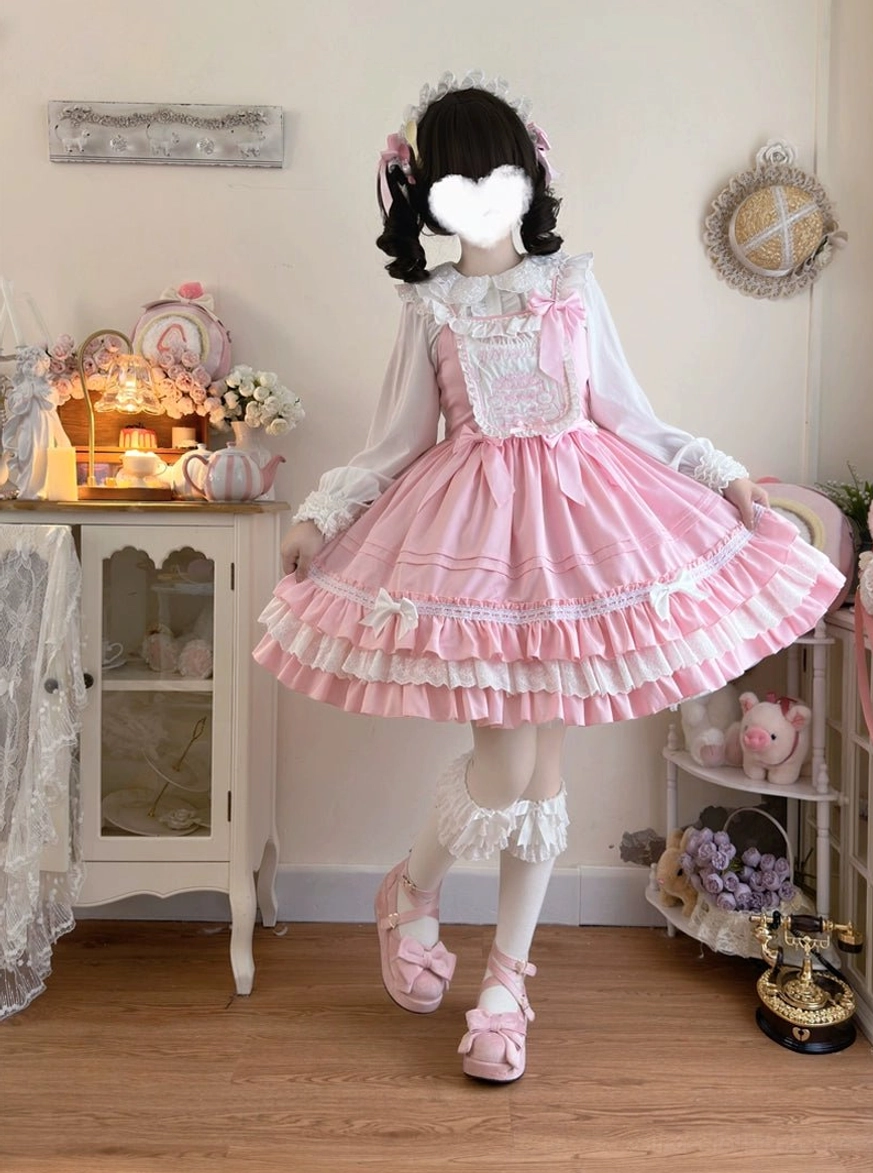 Pink sweet Lolita JSK dress front view flared full skirt pleated design layered lace trims frilly socks and pink platform loafers