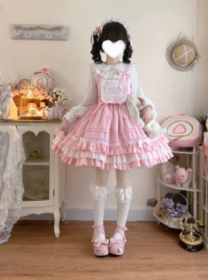Pink sweet Lolita JSK dress three-quarter front view with embroidered lace chest panel bow decorations on straps holding plush rabbit toy