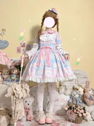 Front three-quarter angle of Sweet Bunny Bear long sleeve Lolita OP dress worn with ruffled tights and pink shoes, showing patchwork design, decorative waist belt, and Peter Pan ruffled collar details