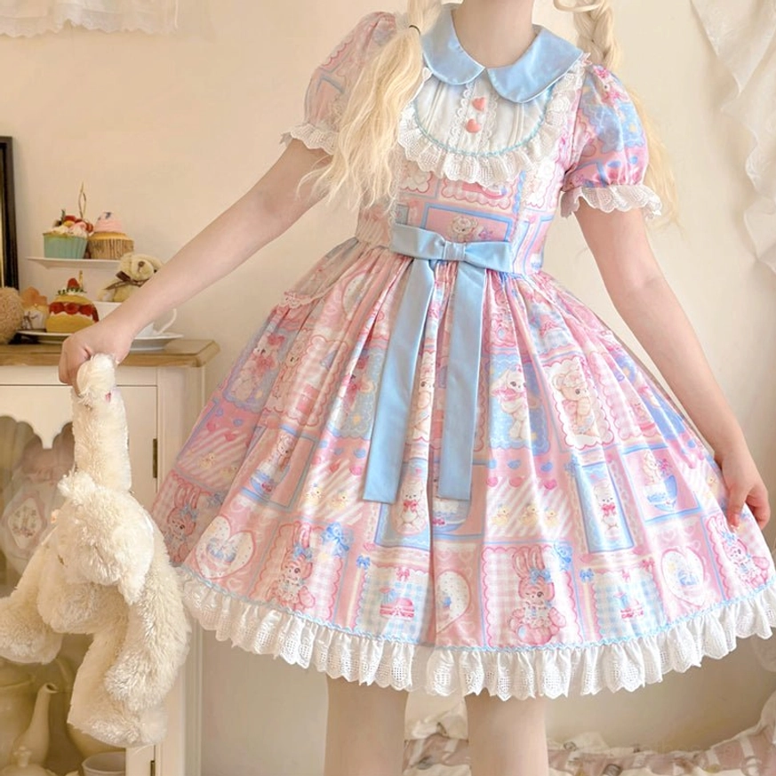 Close-up detail shot of Sweet Bunny Bear Lolita OP dress showing lace ruffle hemline texture, pastel patchwork bunny and bear print quality, and decorative waist sash bow
