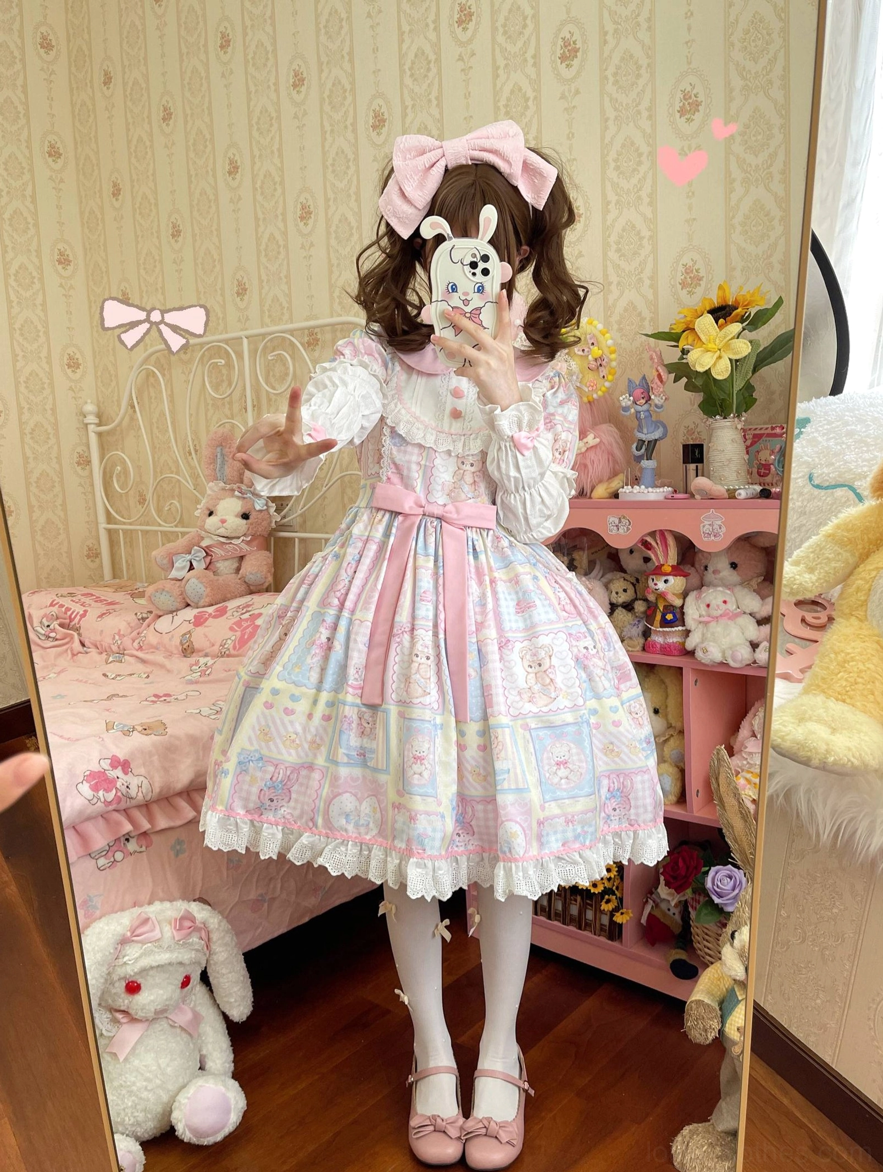 Mirror side full-body view of Sweet Bunny Bear Lolita OP dress showing flared lace hem skirt, pink hair bow, pink Mary Jane shoes, pastel bunny and bear patchwork pattern detail