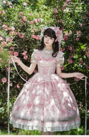 Sweet woodland deer lolita JSK dress full front view model wearing in outdoor flower garden with matching floral hair accessory and ruffled tulle hem