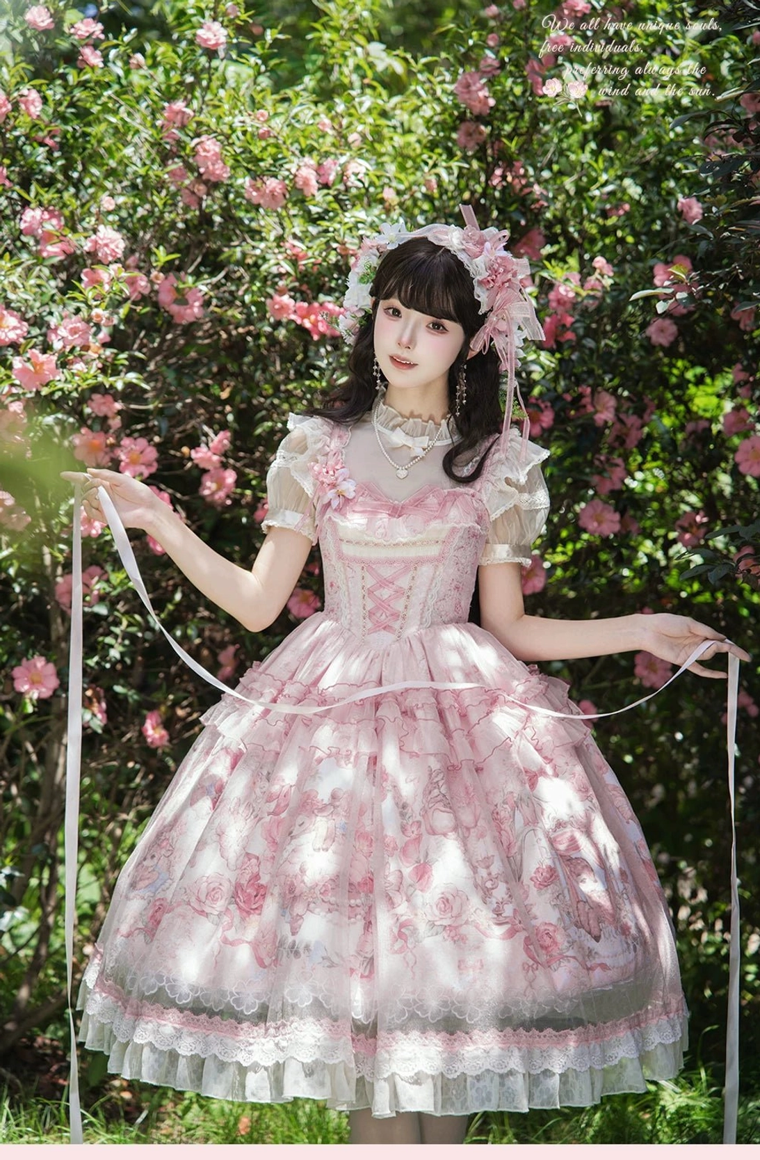 Sweet woodland deer lolita JSK dress full front view model wearing in outdoor flower garden with matching floral hair accessory and ruffled tulle hem