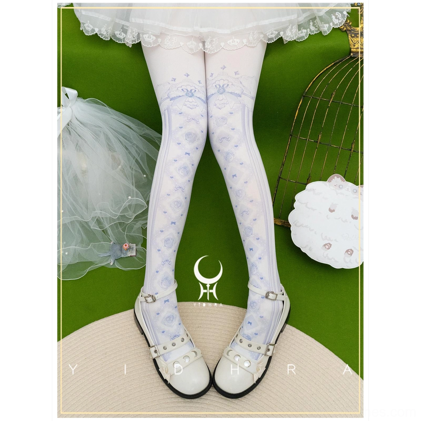 Pale blue floral lolita pantyhose with delicate bow prints and ribbon trim at waistline paired with white lace lace skirt and silver Mary Jane shoes
