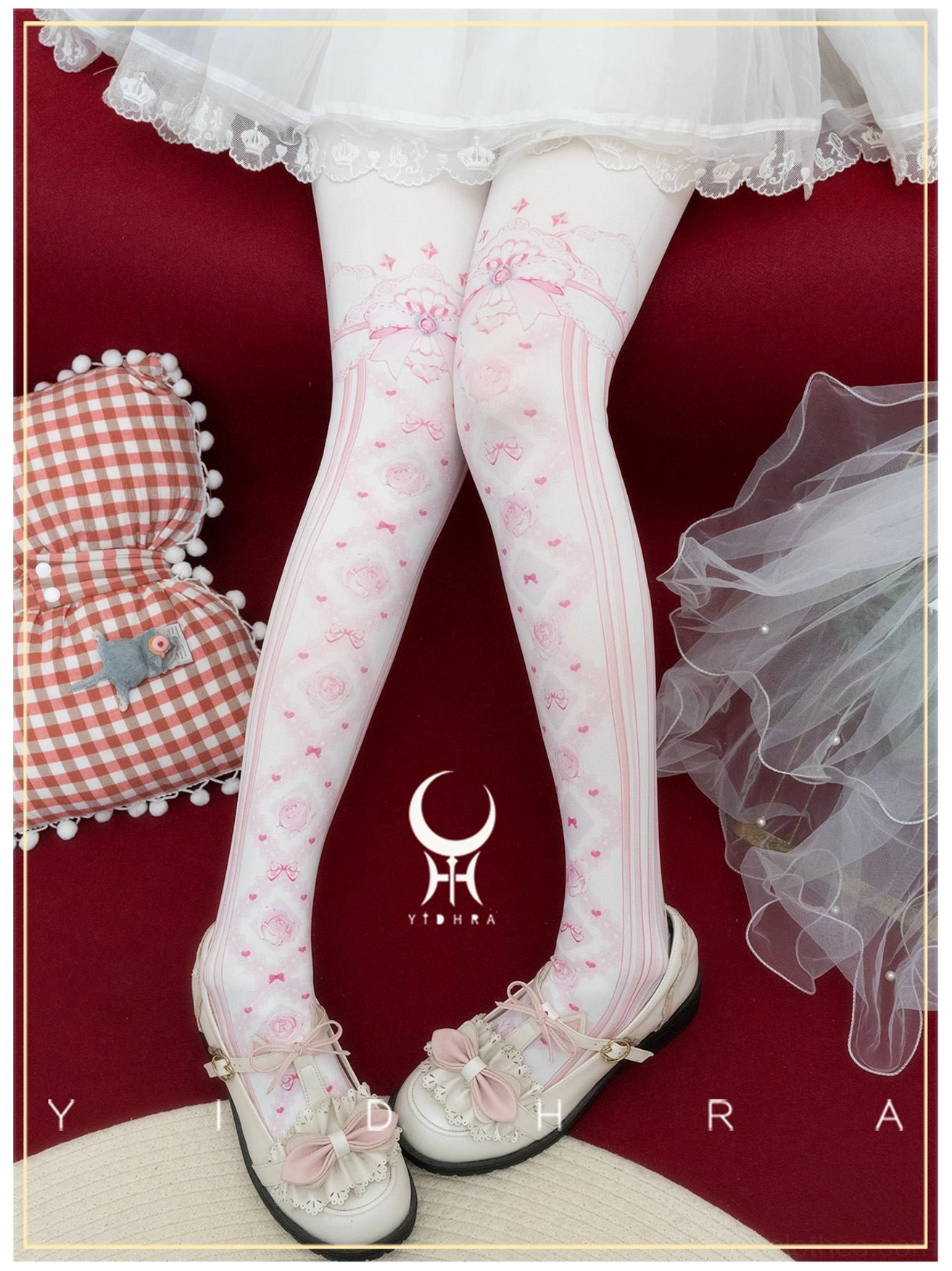 Pink dense floral lolita pantyhose with rose prints and bow decorations at thigh top worn with white ruffled skirt in romantic studio setting
